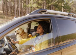 young black woman driving around with her dog