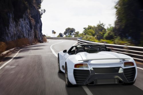 white coupe on the open road