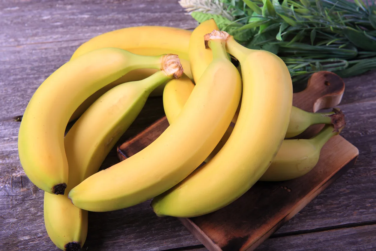 Ripe bananas on wooden table