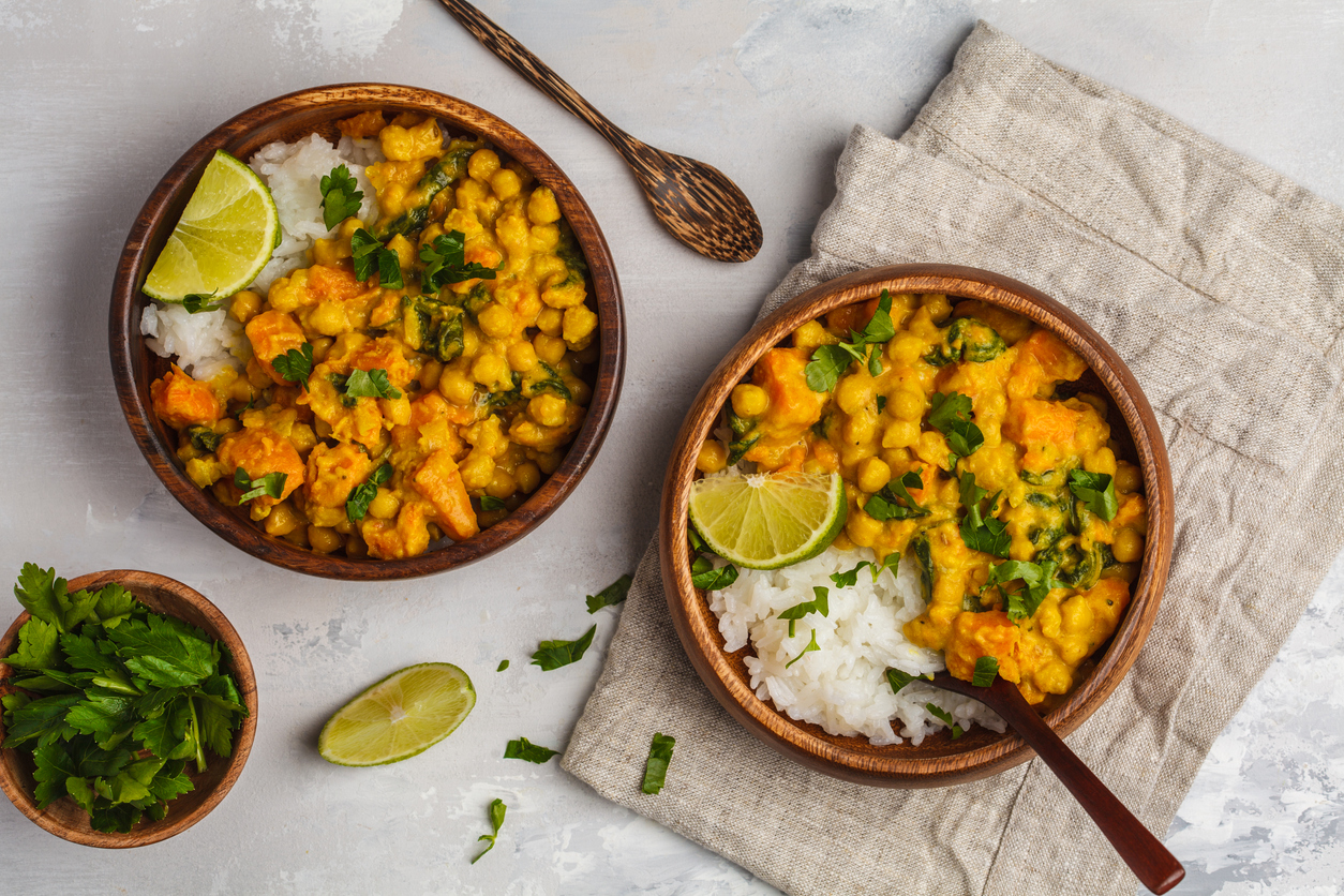 vegan pumpkin curry with chickpeas, turmeric, limes, and cilantro over rice