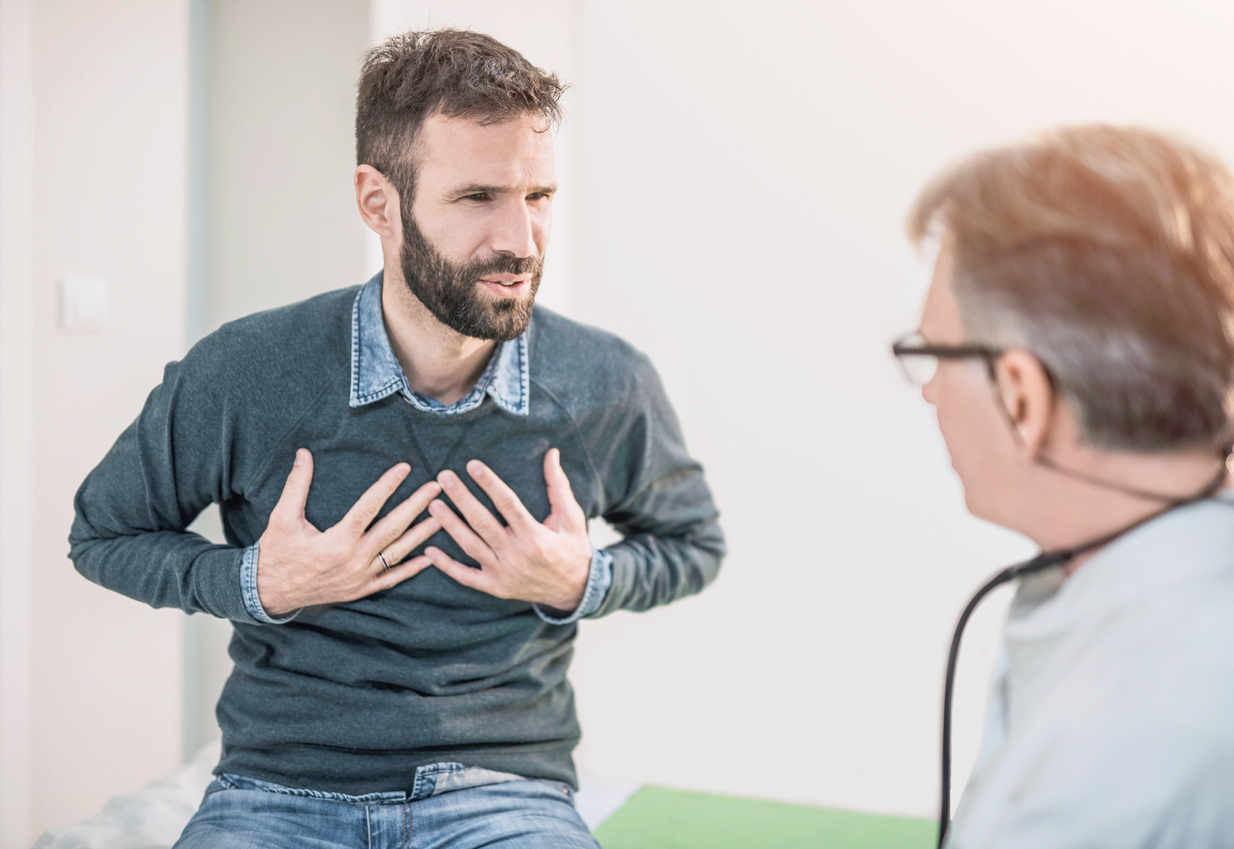 Patient describing chest pain to doctor.