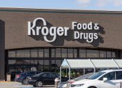 A closeup of a Kroger Food & Drugs store with white logo.