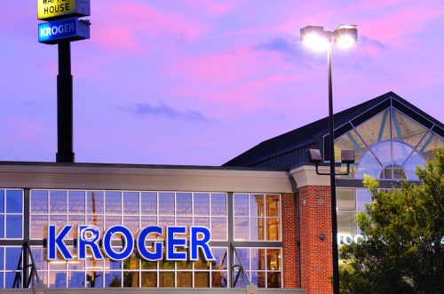 Closeup of a Kroger store at dusk with a purple sky in the background.