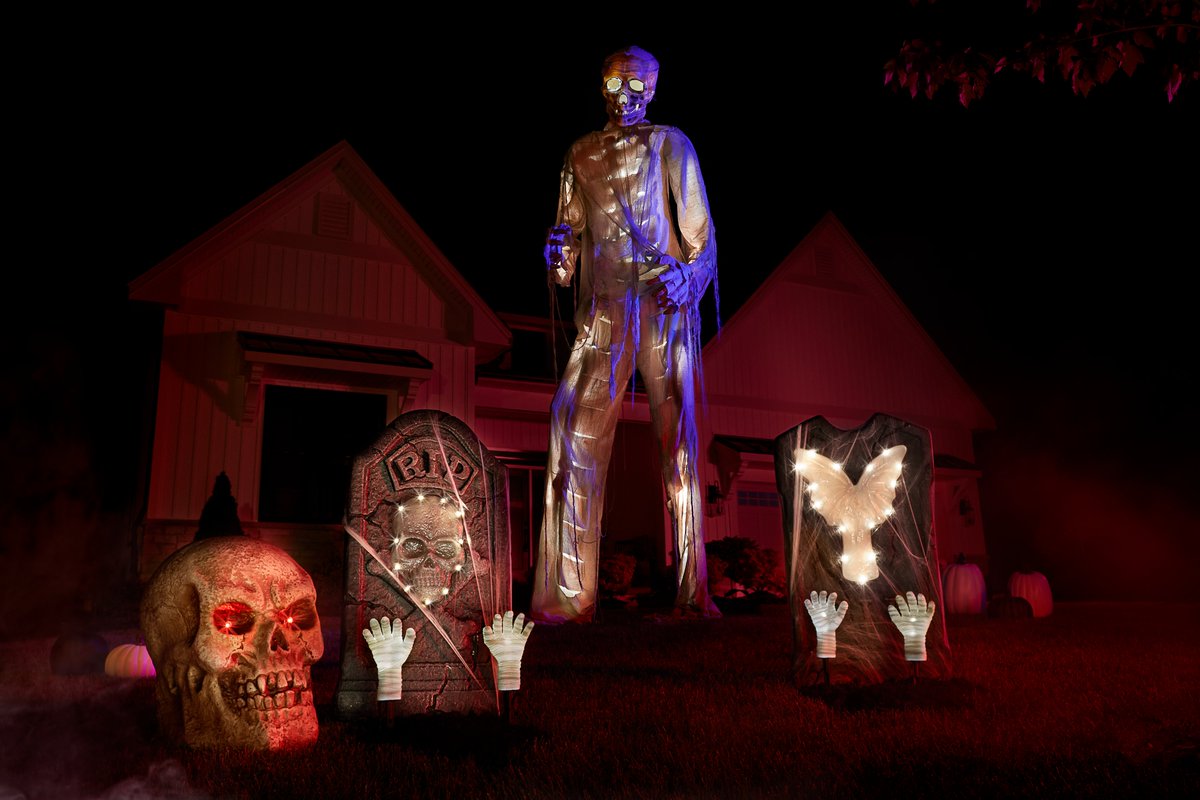A giant skeleton Halloween decoration on someone's front lawn