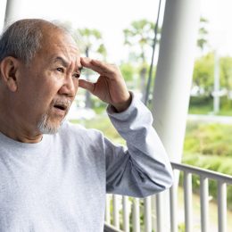 Old asian senior man suffering from headache sickness