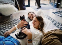Romantic couple at home share tenderness with cat