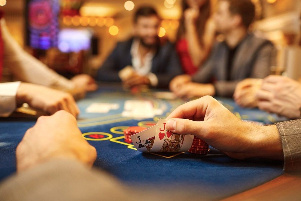 A close up of a player's pocket cards in a poker game in a casino