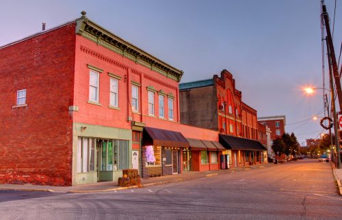 A show down Main Street in Point Pleasant, West Virginia, showing charming red brick storefronts.
