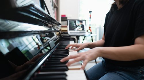 woman learning to play piano when bored