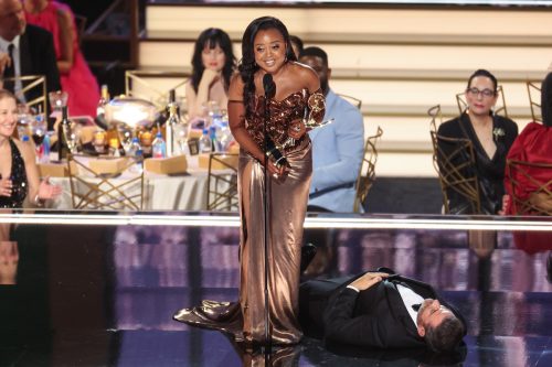 Quinta Brunson accepting her award while Jimmy Kimmel lies on the floor at the 2022 Emmys