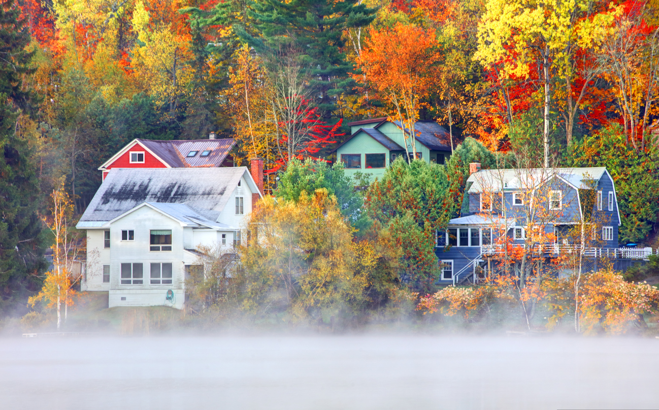 Houses sitting in fog along Saranac Lake in the Adirondack region of New York