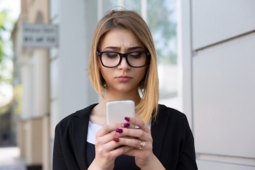 woman looking concerned at phone