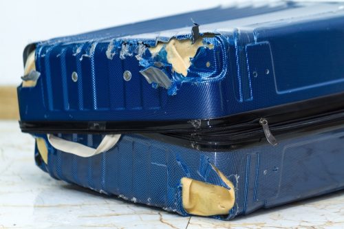 Damaged Blue Suitcase