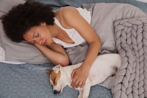 woman and dog sleeping together