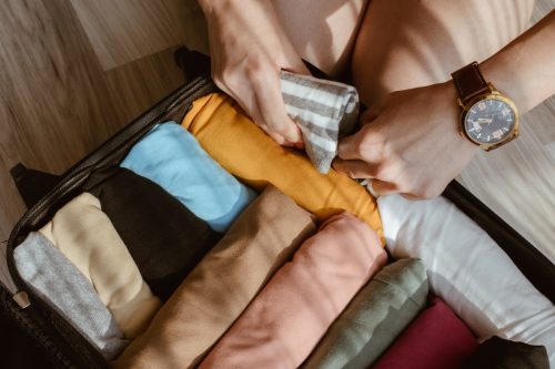 rolling clothes in suitcase