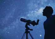 Man Stargazing with a Telescope