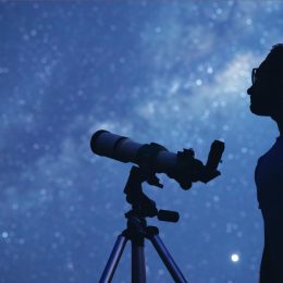 Man Stargazing with a Telescope