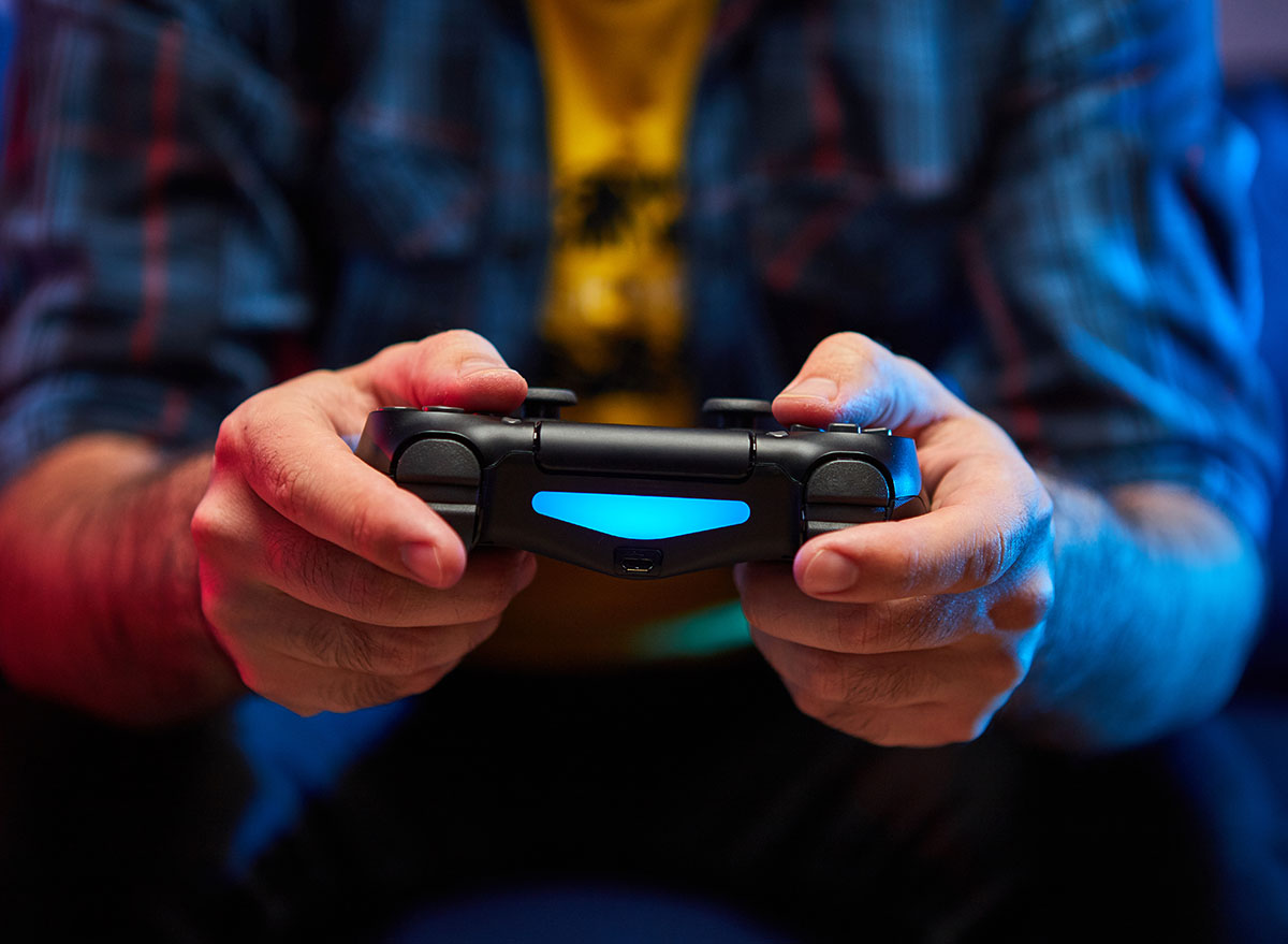 Close up of a man using a gaming controller