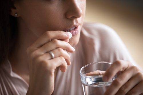 Person Taking Antidepressant with Water