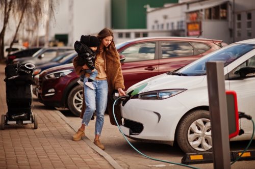 woman charging electric car