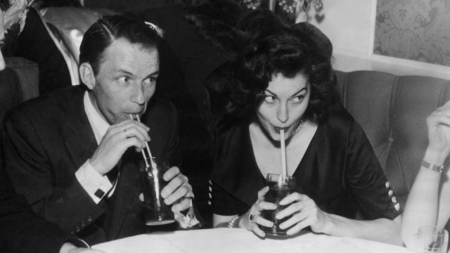 Frank Sintra and Ava Gardner photographed drinking out of straws at a restaurant circa 1951