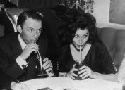 Frank Sintra and Ava Gardner photographed drinking out of straws at a restaurant circa 1951