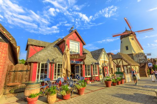A view down the street of Solvang, California, which looks like a Dutch village with a windmill.