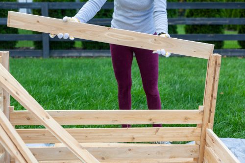 woman with gloves building a shed - things to do when bored