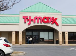 The front of a TJ Maxx store with a green roof and red logo