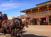 A stagecoach filled with tourists travels the historic streets of Tombstone, Arizona