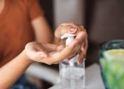 A closeup of someone using hand sanitizer from a bottle