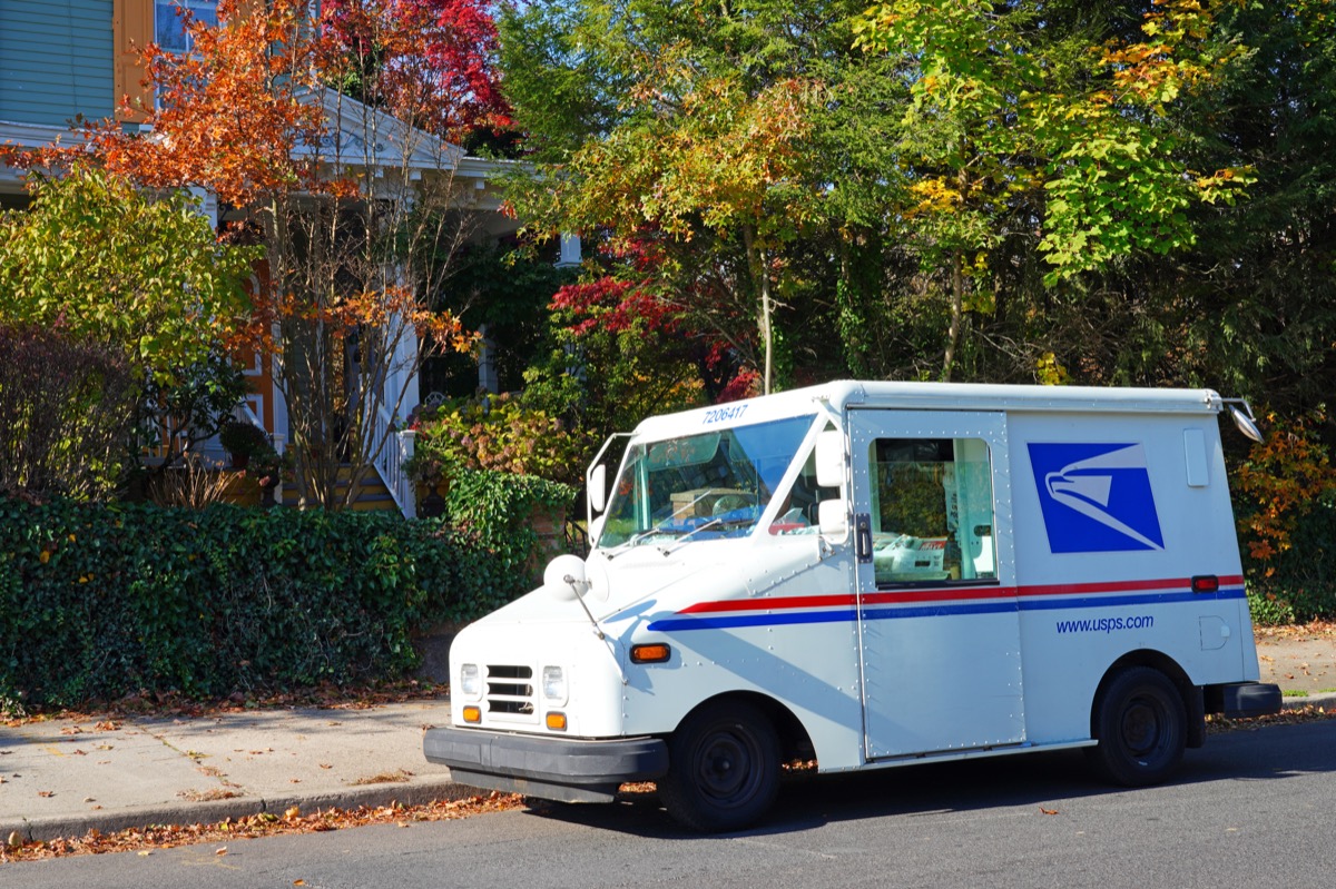 USPS truck parked in front of house