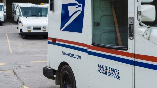 Delivery vehicles parked at the United States Post Office in downtown Rochester, Michigan. With almost 600,000 employees, the United States Postal Service is the second largest civilian employer in the United States.