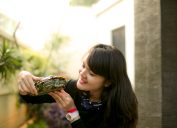 young Woman Holding Turtle