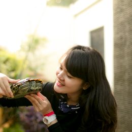 young Woman Holding Turtle