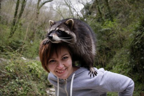 A woman and raccoon.
