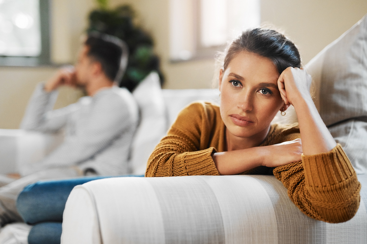 Shot of a young woman ignoring her boyfriend after having an argument on the couch