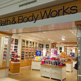 The entrance to a Bath & Body Works store in the mall with signs advertising a sale.