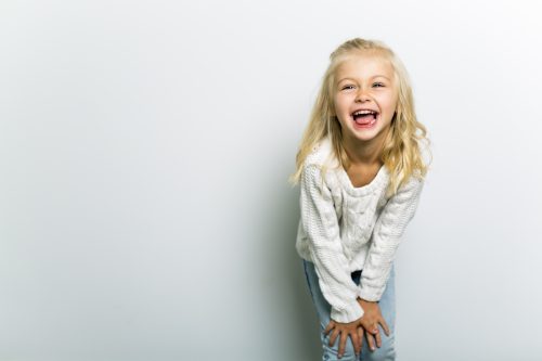 5-year-old-girl laughing at funny kids' jokes