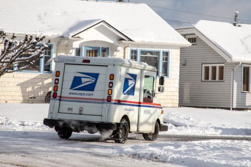 US Postal Service Jeep Delivering Mail During Unusual Winter Snow Storm
