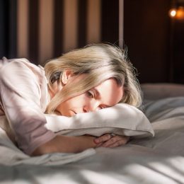 Tired middle aged woman lying in bed feeling depression