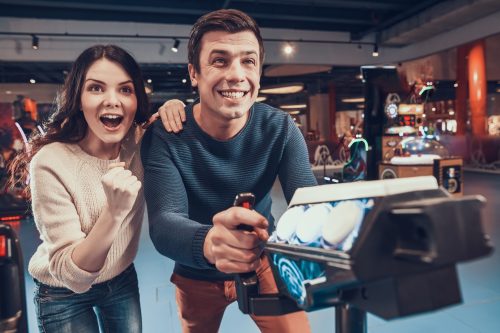 couple playing arcade games for their first date