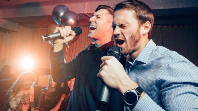 men singing karaoke