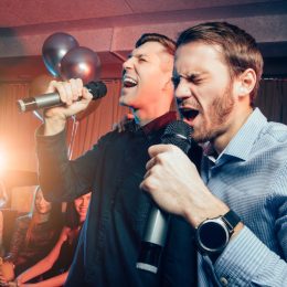 men singing karaoke