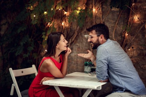 man and woman flirting at restaurant