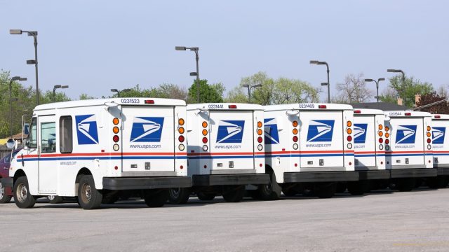 Fleet of USPS mail delivery trucks