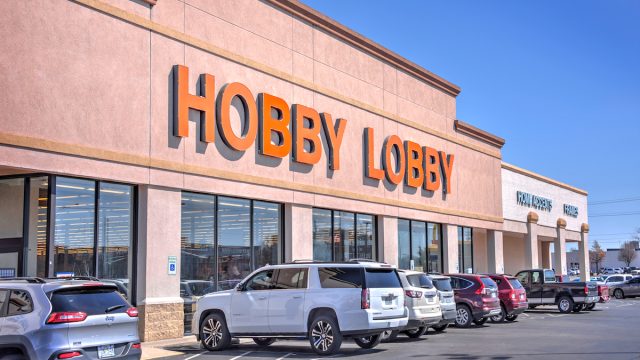 A view of a Hobby Lobby store with cars parked out front.