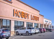 A view of a Hobby Lobby store with cars parked out front.