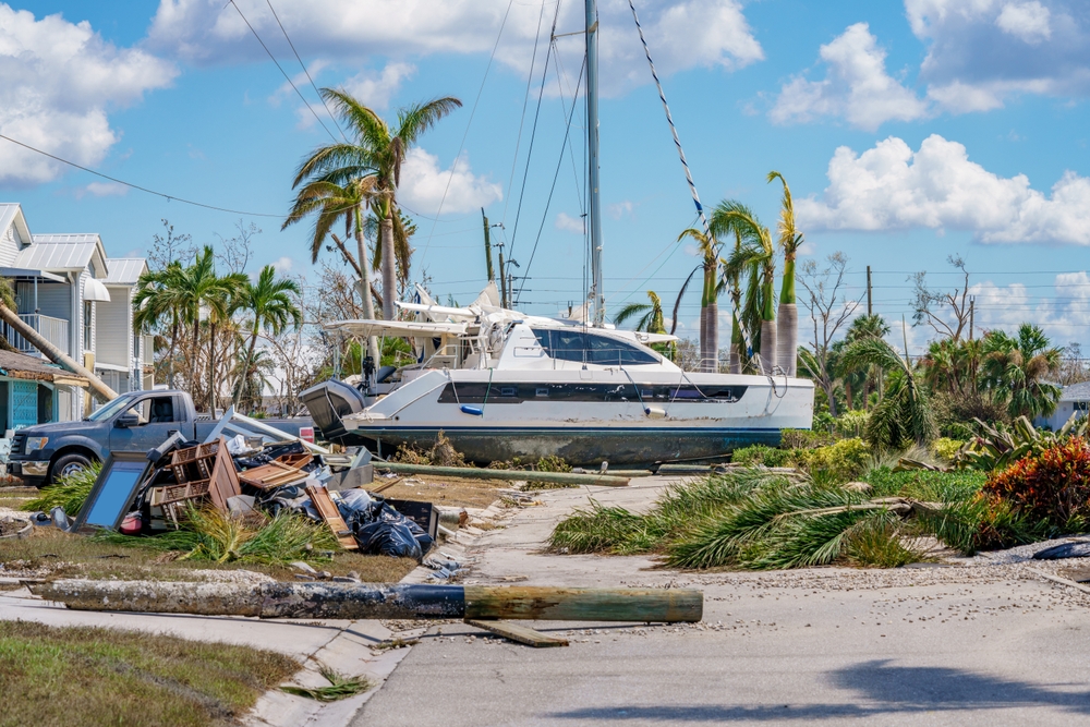 A catamaran thrown into the street after Hurricane Ian