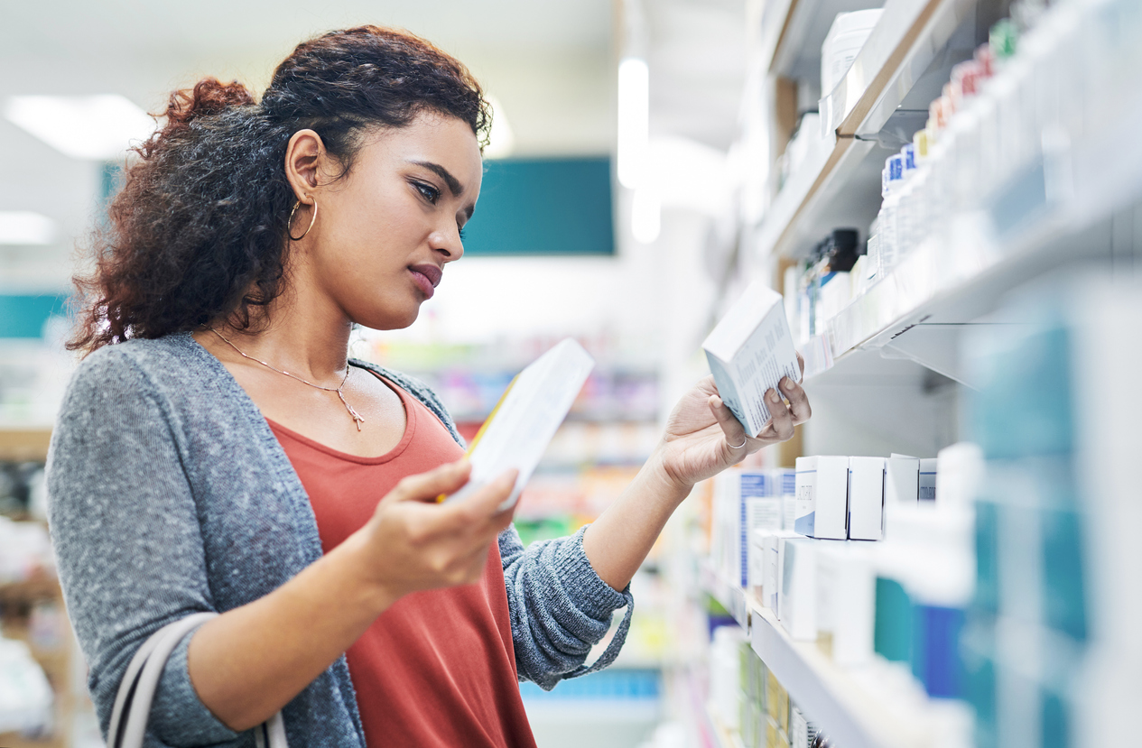 Woman looking at shelves in a pharmacy.
